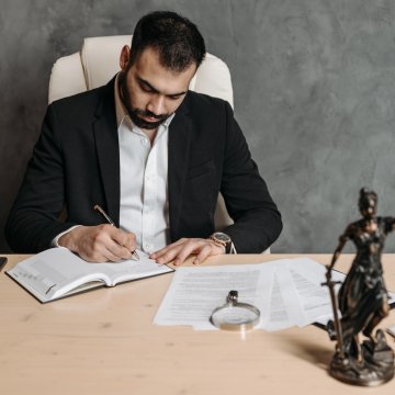 lawyer writing down notes on their next case